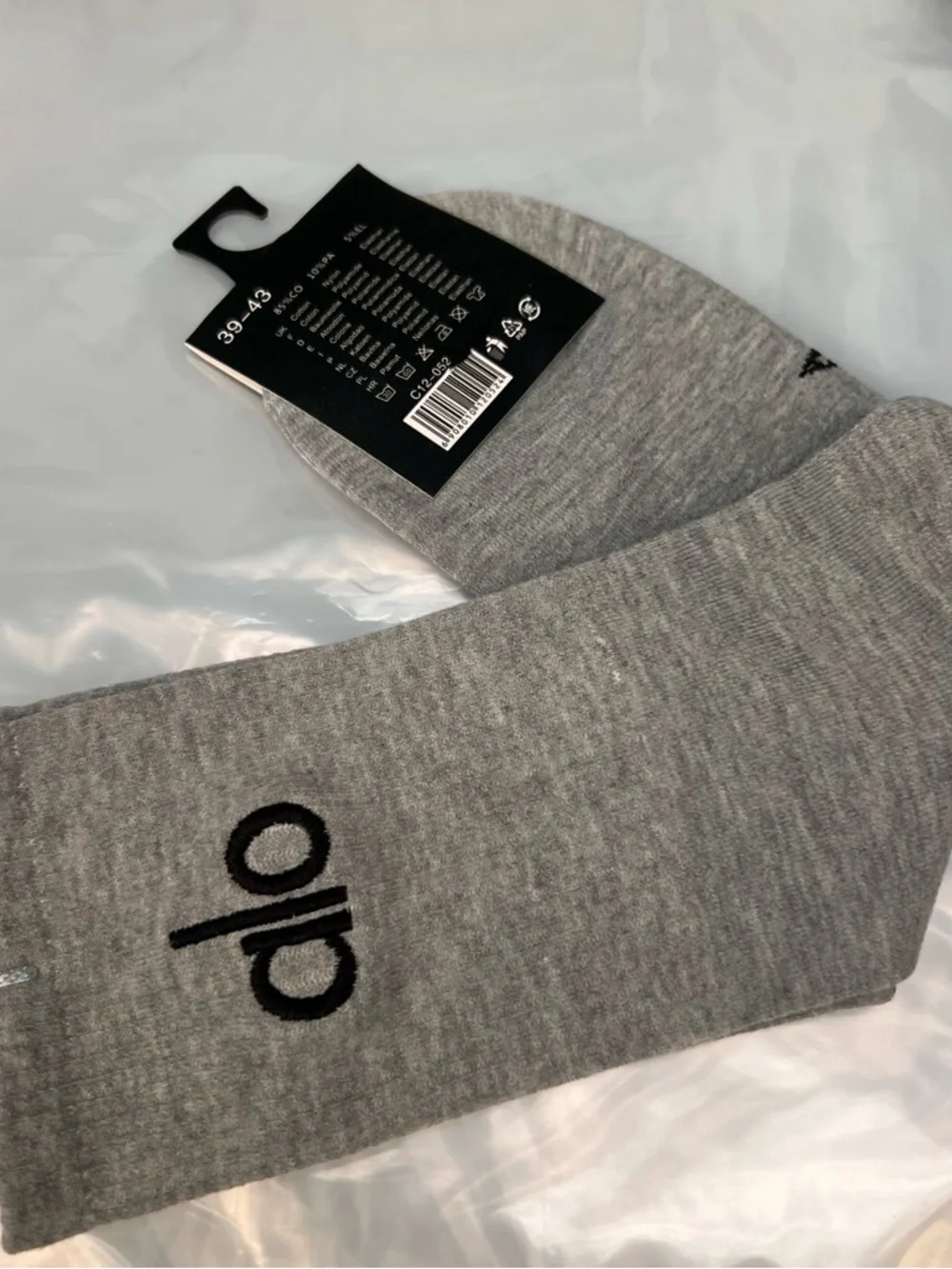 ALO Yoga unisex half crew understated socks in gray embroidered logo